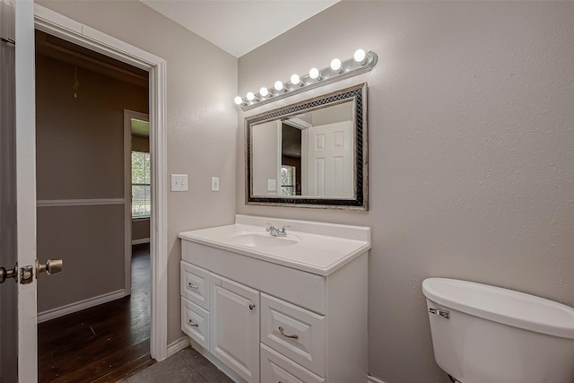 bathroom featuring tile patterned floors, vanity, and toilet