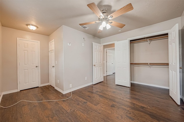 unfurnished bedroom featuring dark hardwood / wood-style flooring, a textured ceiling, a closet, and ceiling fan