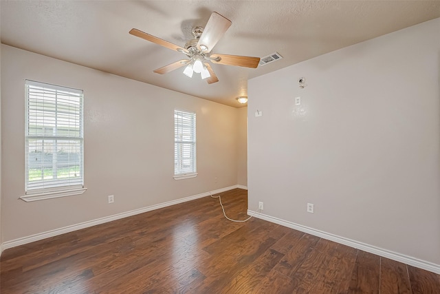 unfurnished room with dark wood-type flooring and ceiling fan