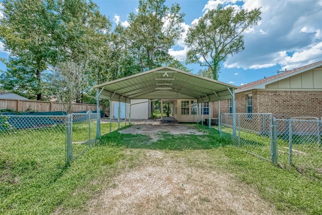 view of vehicle parking featuring a carport and a lawn