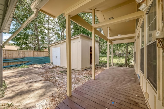 wooden terrace featuring a storage shed