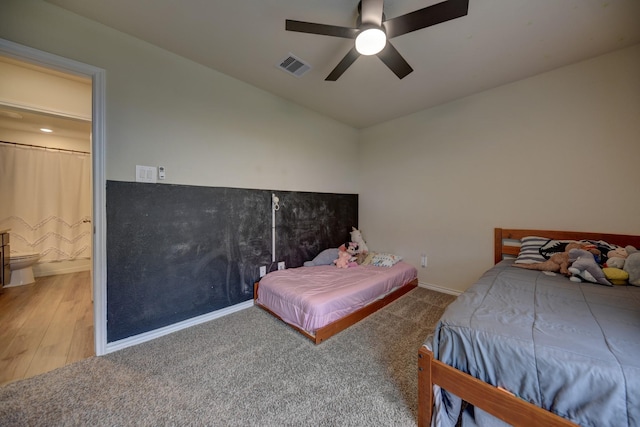 bedroom featuring ceiling fan, ensuite bathroom, and carpet