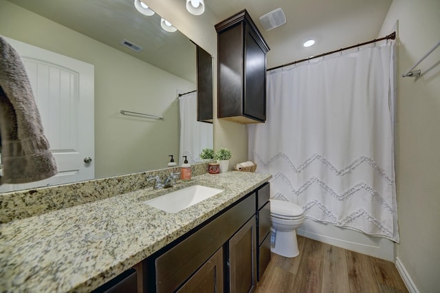 full bathroom featuring shower / tub combo, vanity, toilet, and hardwood / wood-style floors