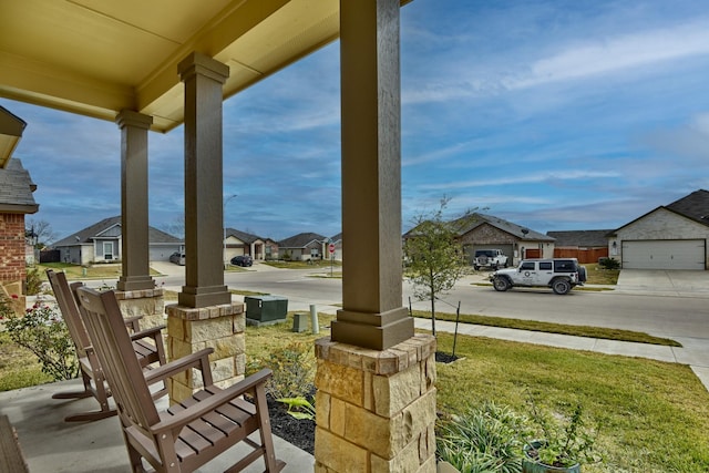 view of patio / terrace with a garage and covered porch