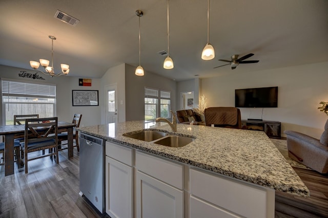 kitchen with sink, white cabinetry, hanging light fixtures, stainless steel dishwasher, and an island with sink