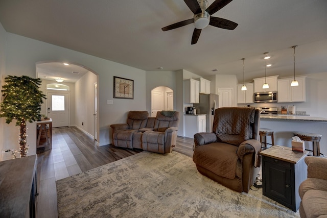 living room featuring dark hardwood / wood-style floors and ceiling fan