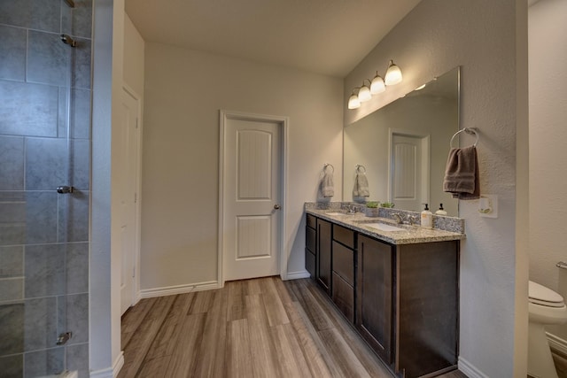 bathroom featuring vanity, hardwood / wood-style flooring, and toilet