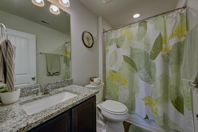 full bathroom with vanity, shower / bath combination with curtain, and toilet