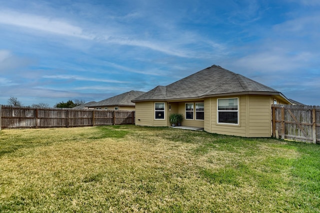 back of house with a lawn