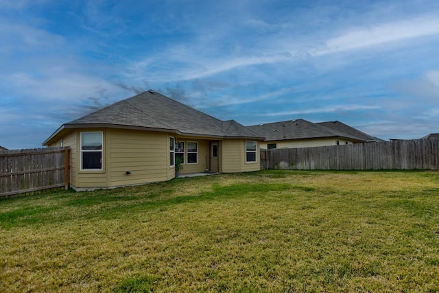 back of house featuring a yard