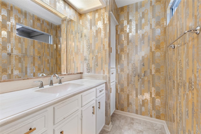 bathroom featuring vanity and a textured ceiling