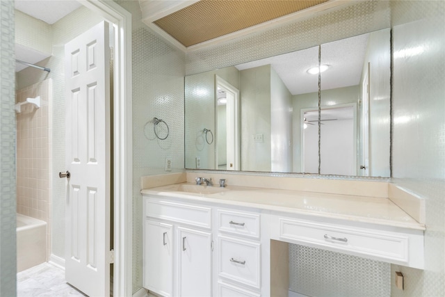 bathroom featuring vanity and tiled shower / bath