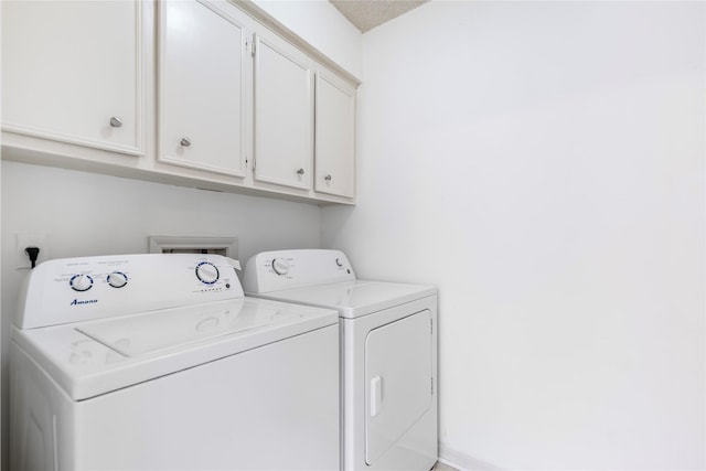 laundry area featuring independent washer and dryer and cabinets