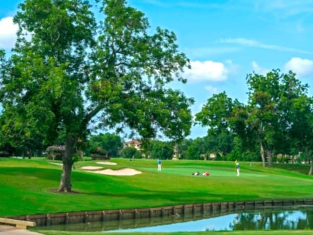 view of home's community with a water view and a lawn