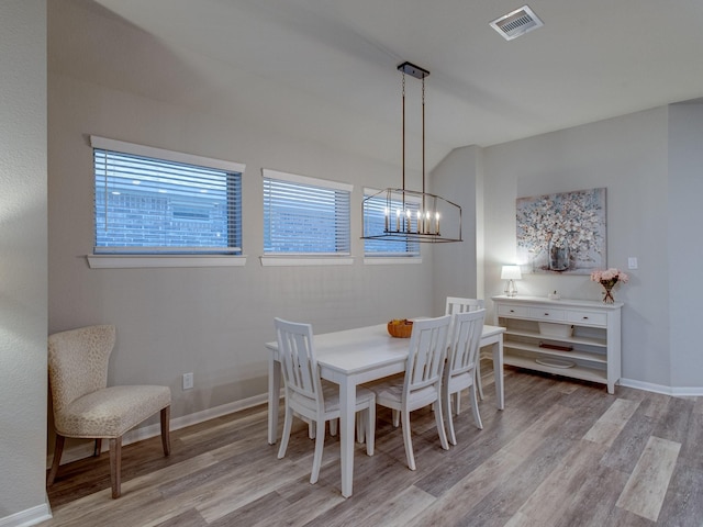 dining area with a notable chandelier and light wood-type flooring