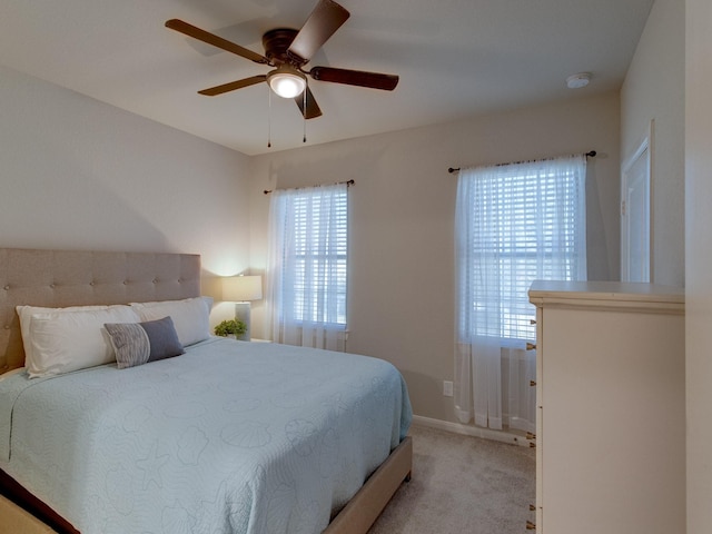 bedroom featuring ceiling fan and light carpet