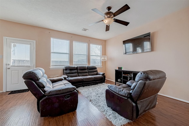 living room featuring wood-type flooring and ceiling fan