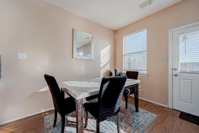 dining space featuring wood-type flooring