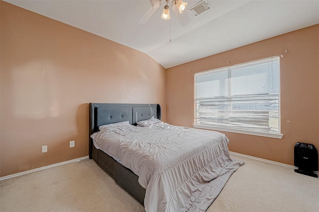 carpeted bedroom with vaulted ceiling and ceiling fan