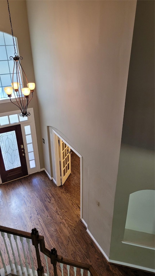 entrance foyer featuring dark hardwood / wood-style flooring and a chandelier