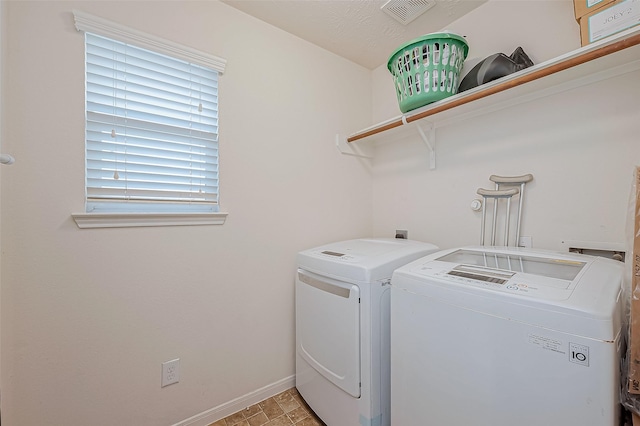 laundry room featuring washing machine and clothes dryer