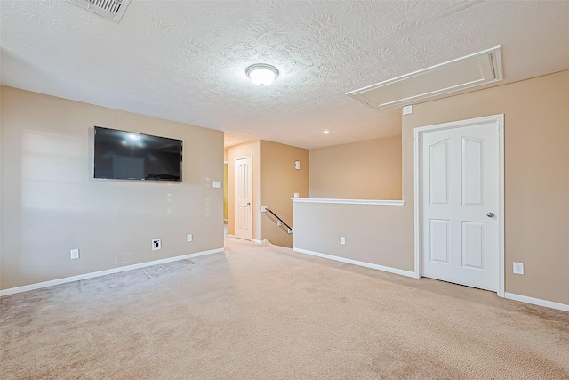 interior space with carpet flooring and a textured ceiling