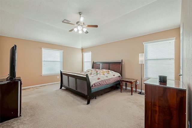 bedroom with lofted ceiling, light carpet, and ceiling fan