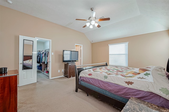 bedroom with ceiling fan, lofted ceiling, a spacious closet, and a closet