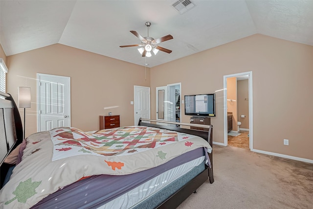 carpeted bedroom featuring ensuite bathroom, lofted ceiling, and ceiling fan