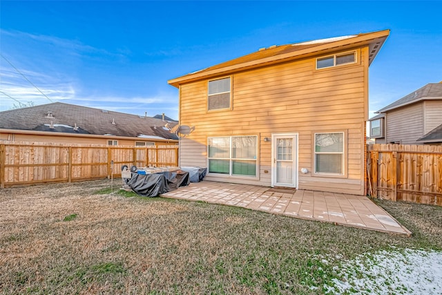 rear view of property with a patio and a yard