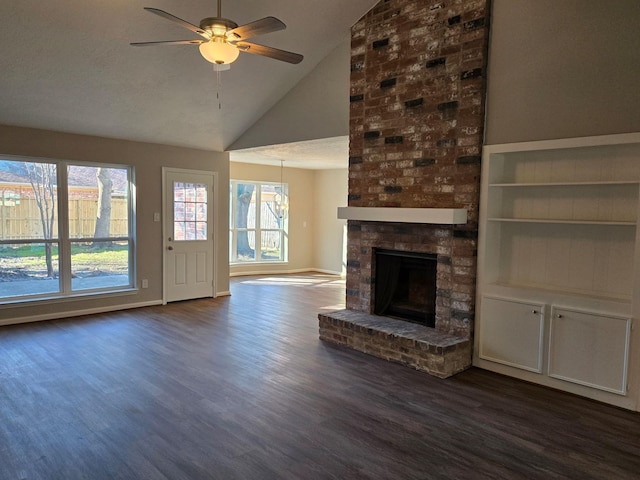 unfurnished living room with dark wood-type flooring, ceiling fan, lofted ceiling, and a fireplace