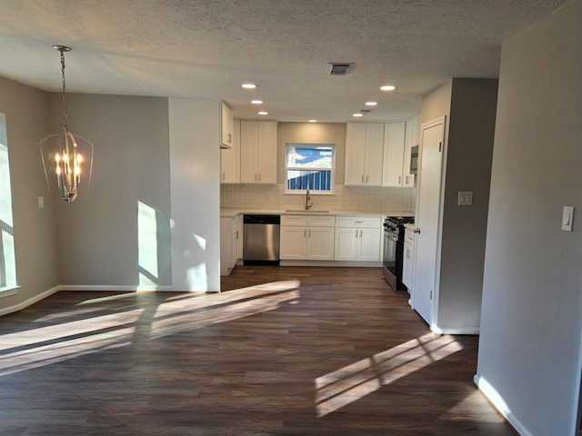 kitchen with appliances with stainless steel finishes, dark hardwood / wood-style floors, decorative light fixtures, tasteful backsplash, and white cabinets