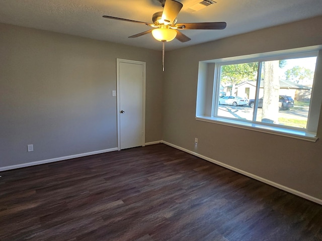 unfurnished room with dark hardwood / wood-style floors and ceiling fan