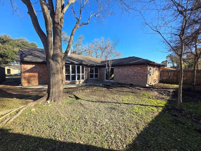 back of house with a yard and a patio area