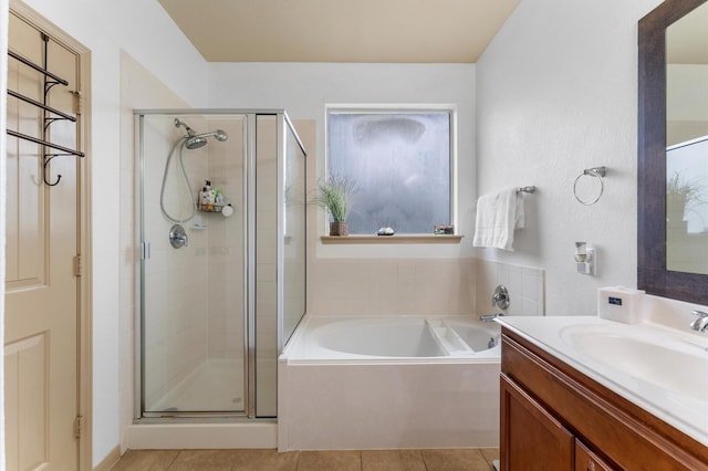 bathroom with tile patterned floors, shower with separate bathtub, and vanity