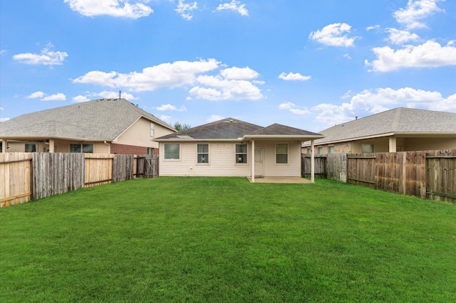 rear view of house with a patio and a yard