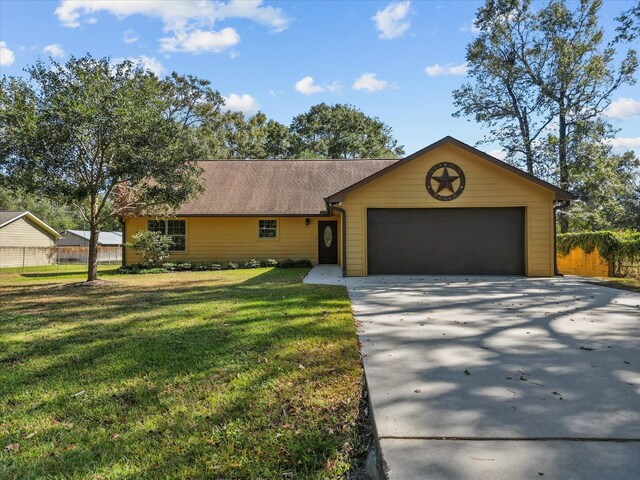 ranch-style house featuring a garage and a front lawn