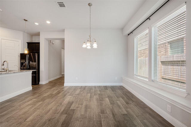 interior space with dark hardwood / wood-style flooring, sink, and a notable chandelier