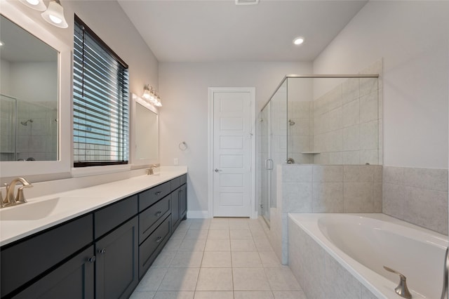 bathroom featuring vanity, tile patterned flooring, and separate shower and tub