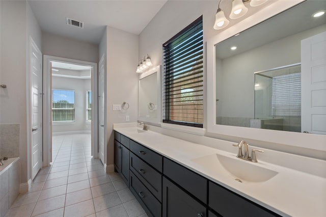 bathroom featuring vanity, separate shower and tub, and tile patterned floors