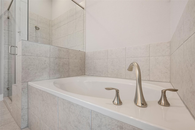 bathroom featuring independent shower and bath