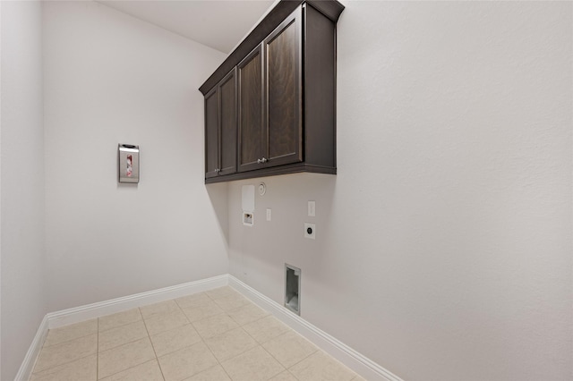 clothes washing area with gas dryer hookup, cabinets, washer hookup, and electric dryer hookup