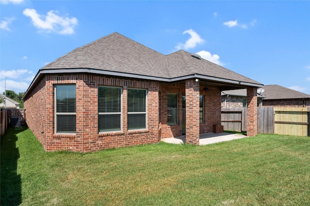 back of property featuring a yard and a patio