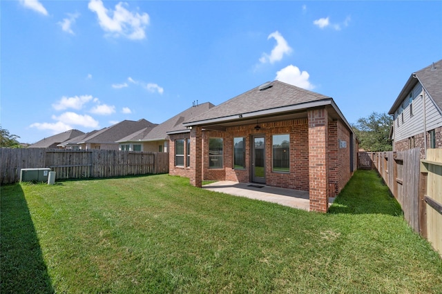 rear view of property with a yard and a patio