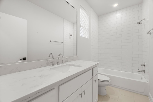 full bathroom featuring vanity, tile patterned floors, toilet, and tiled shower / bath