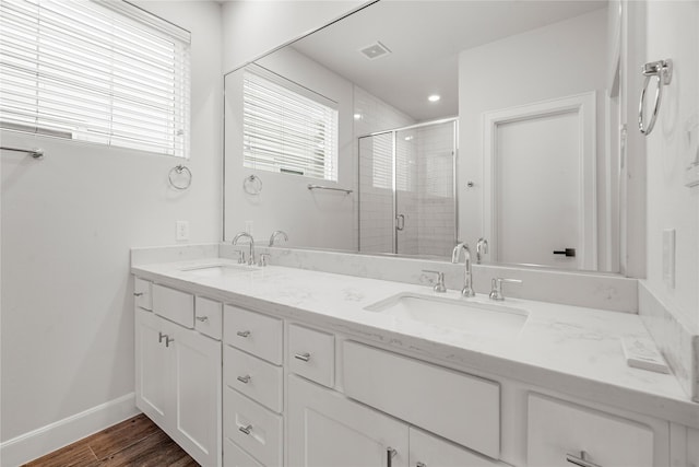 bathroom featuring vanity and a shower with shower door