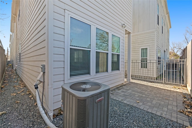 view of side of property with a patio and central AC unit