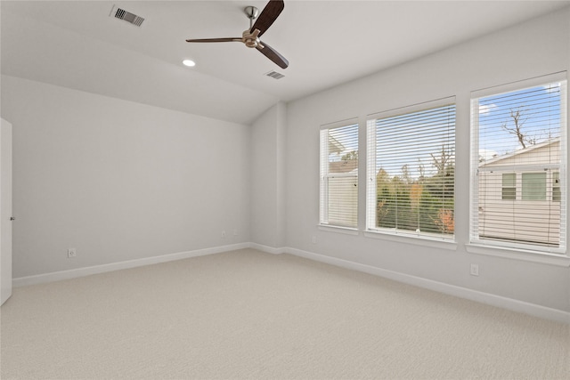 spare room featuring lofted ceiling, carpet floors, and ceiling fan