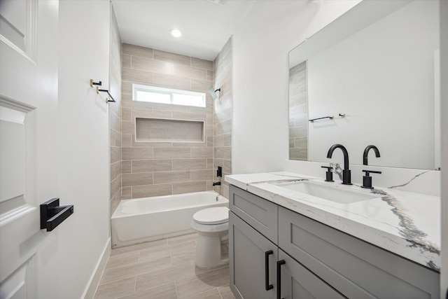 full bathroom with vanity, toilet, and tiled shower / bath combo