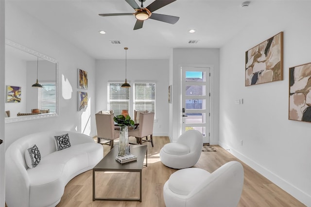 living room with ceiling fan and light wood-type flooring